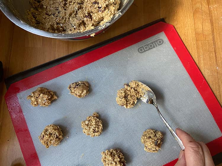 unbaked cranberry and oat cookies on baking sheet.