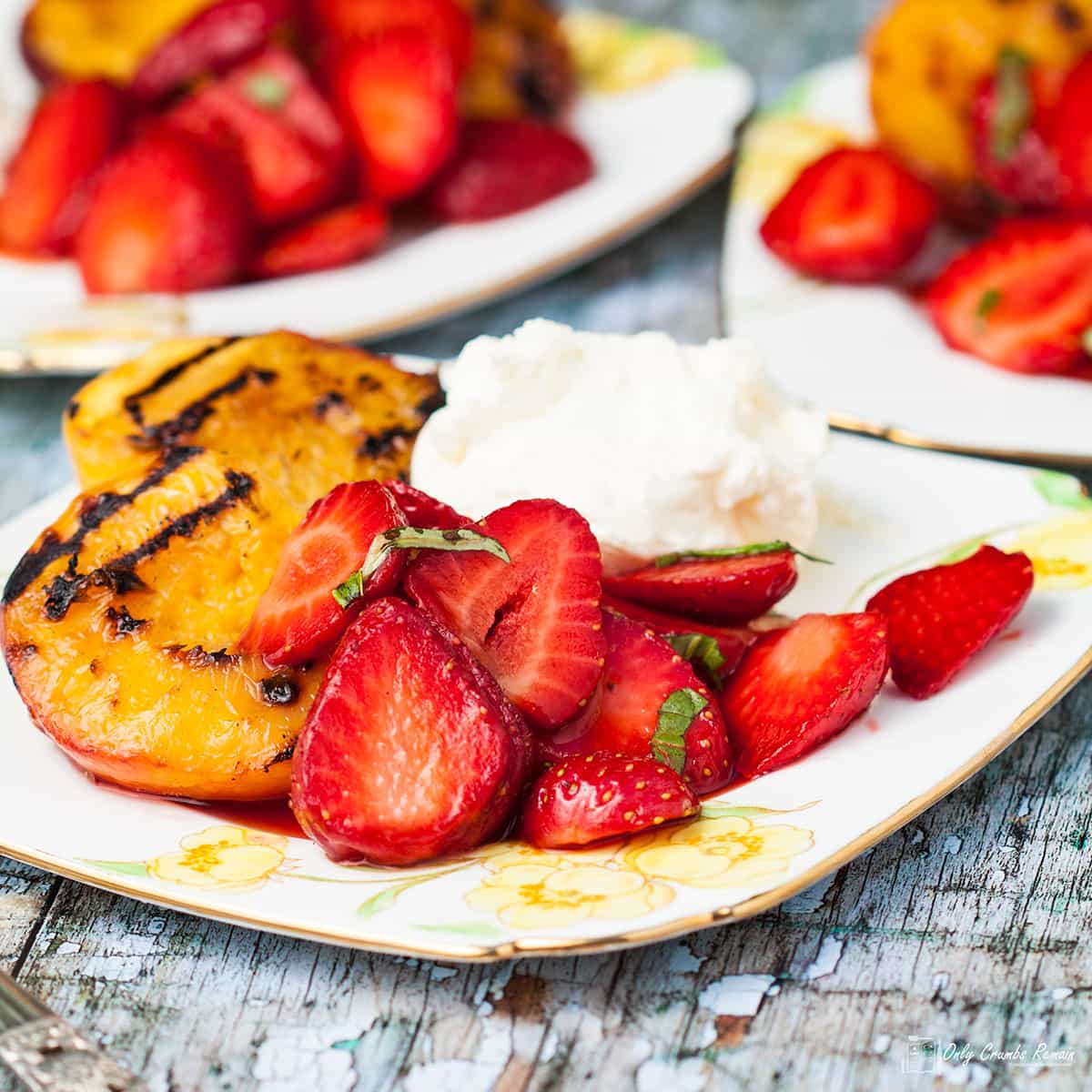 3 plates of griddled peaches with strawberries.