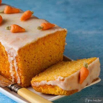 Swiss carrot cake decoarted with marzipan carrots, with slic laying down.
