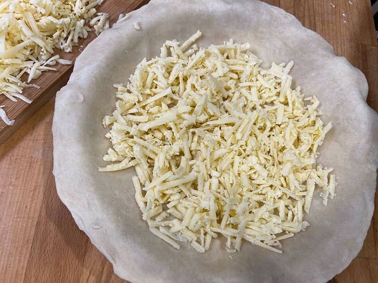 grated cheese in pastry case.