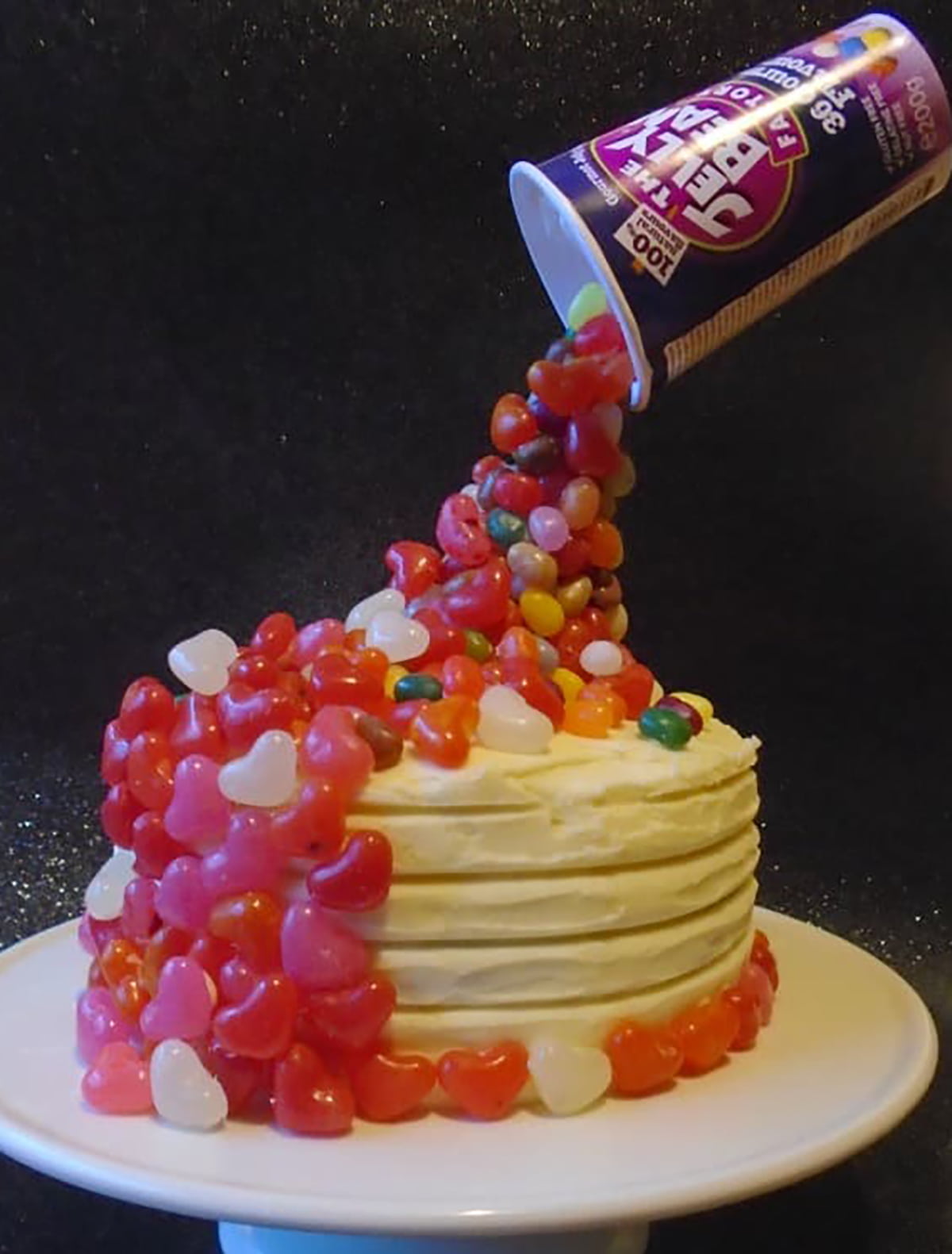 jelly beans appearing to spill onto a cake. 