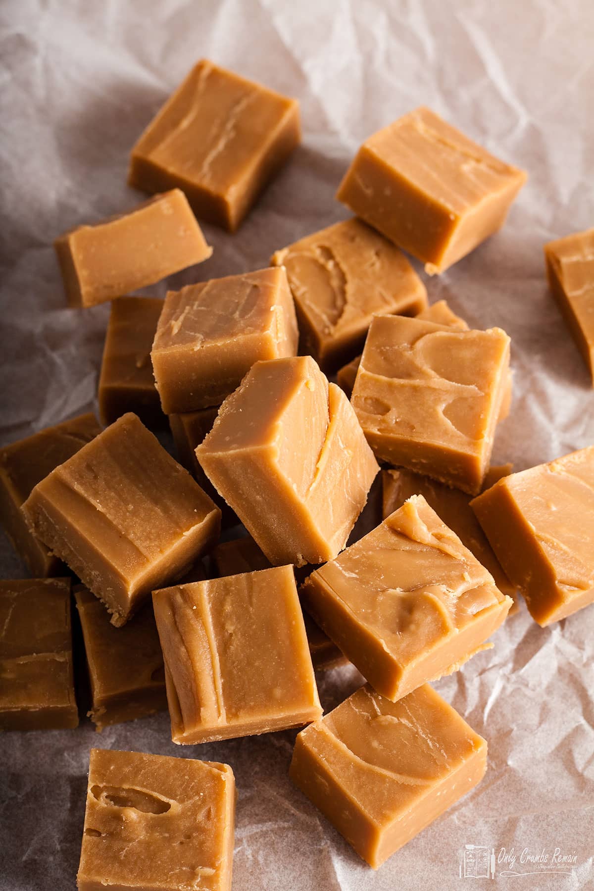 pile of traditional vanilla fudge on crumbled paper.