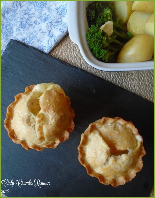 2 chicken and leek pies with vegetables in a side dish