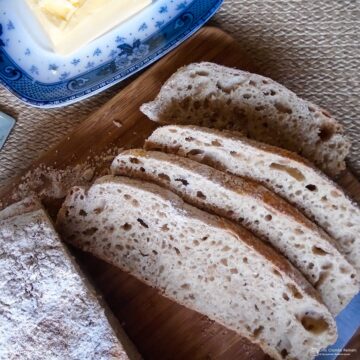 sliced loaf of no knead bread on board.
