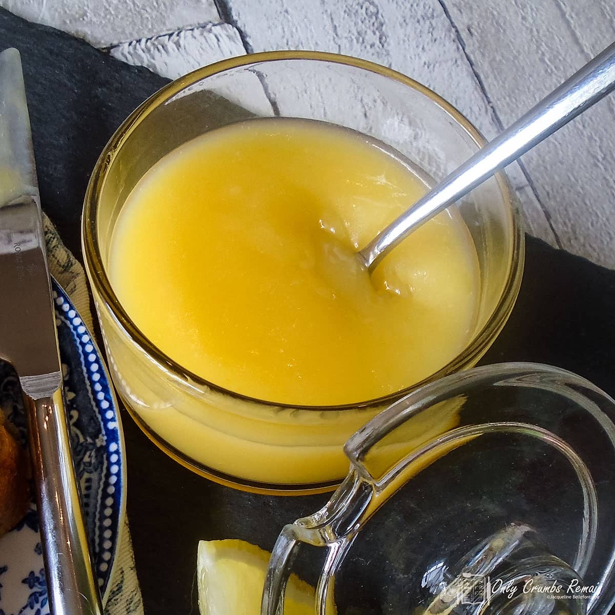 jar of homemade lemon curd with spoon.