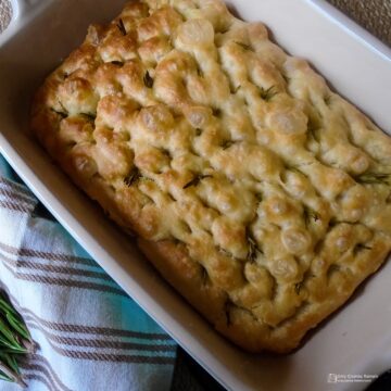 Baked Rosemary and garlic focaccia in baking dish.