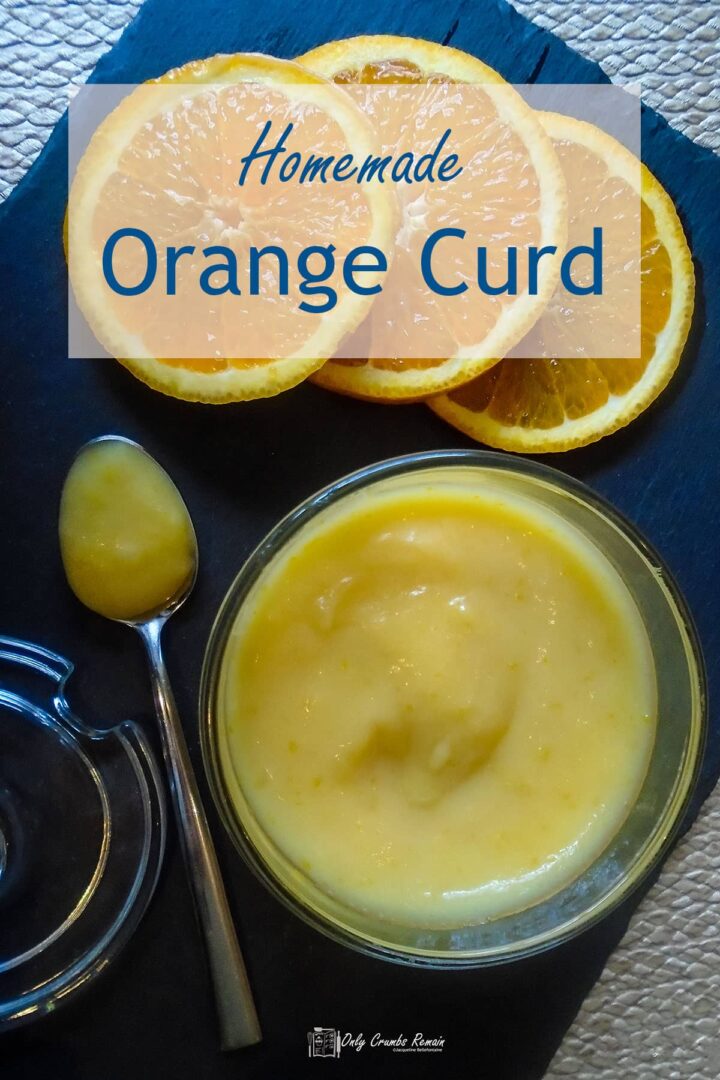 jar of orange curd with spoon on side.