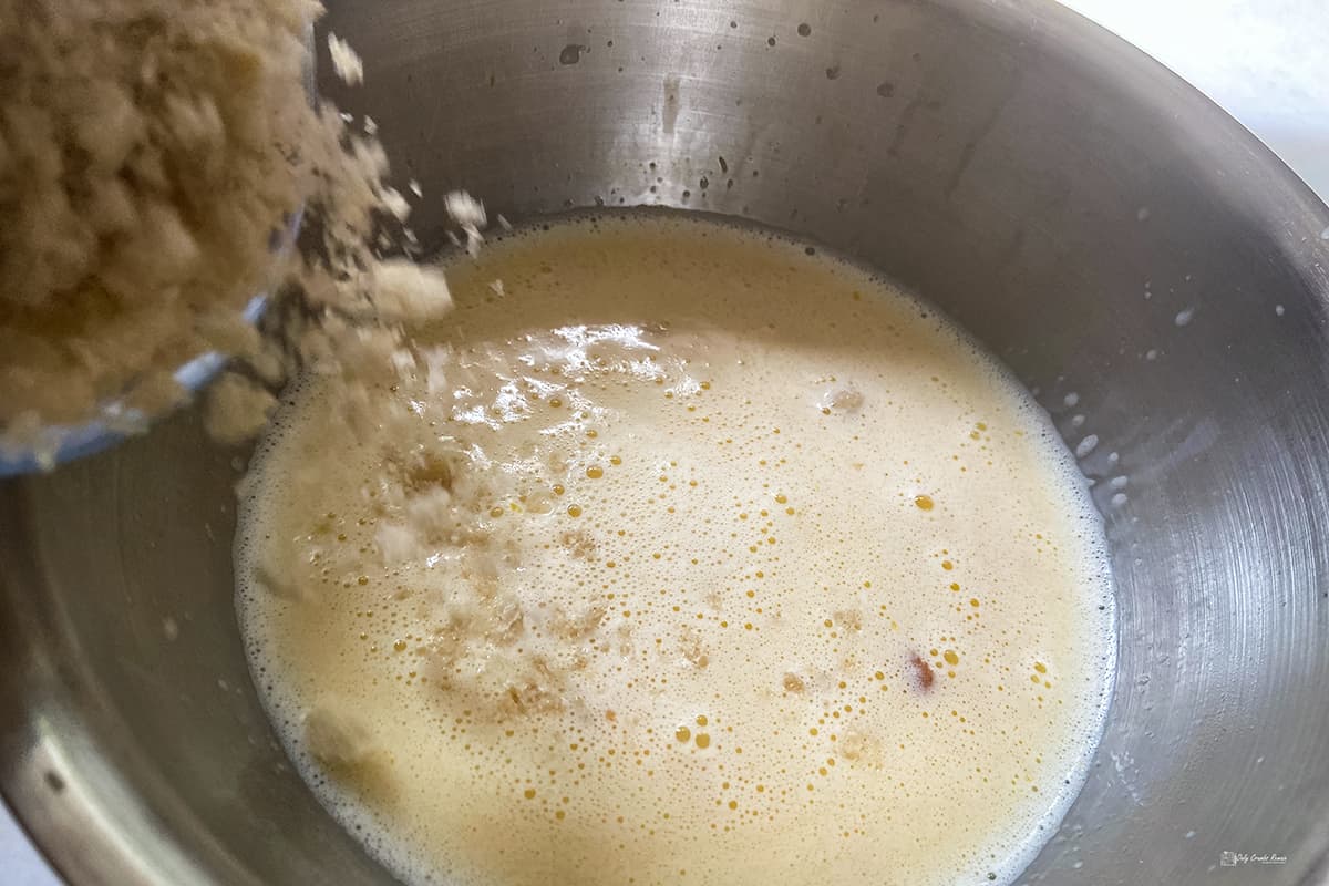 adding breadcrumbs to the custard mixture.