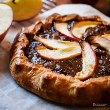 close up of mincemeat and apple galette on greaseproof paper placed on a cooling rack.