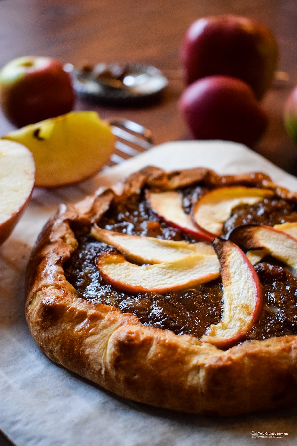 mincemeat and apple galette with whole and quartered apples behind.