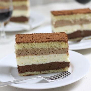 slice tripple chcolate mousse cake on plate.