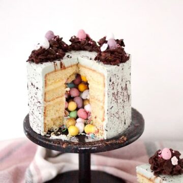cut open easter pinata cake on stand.