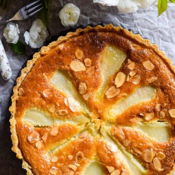 Classic pear and almond tart in pastry tin.