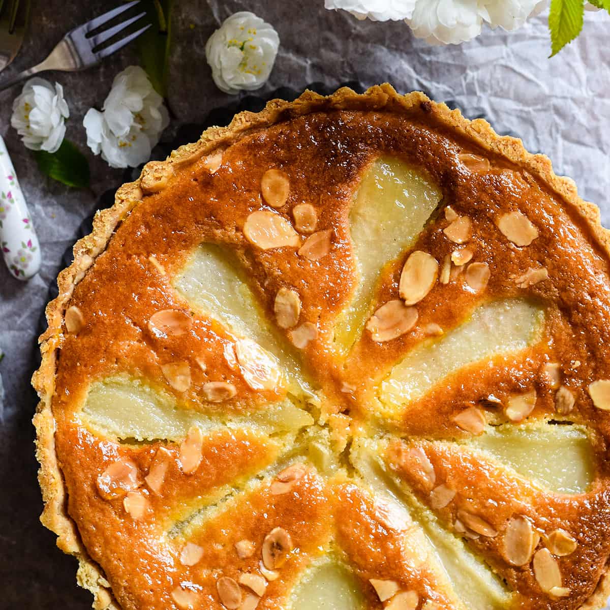 Classic pear and almond tart in pastry tin.