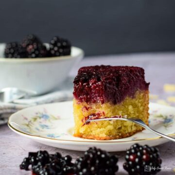 slice of blackberry and almond upside down cake on a plate .