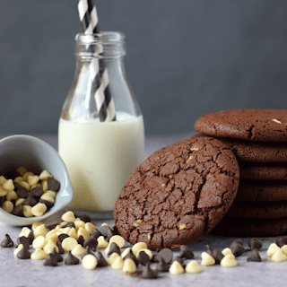 stack of double chcocolate cookies with bottle of milk behind