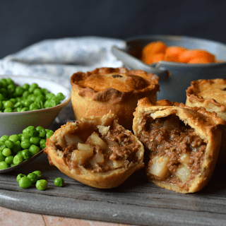 3 vegetarian meat and potato pies, one cut open