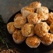 pile of cheesy walnut and rosemary mini muffins on a plate