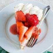 slice of easy baked strawberry cheesecake on plate with fork.