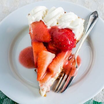 slice of easy baked strawberry cheesecake on plate with fork.