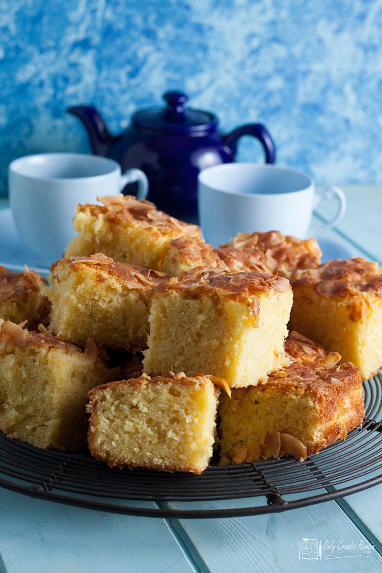 Squares of pineapple and coconut traybake on a wire rack