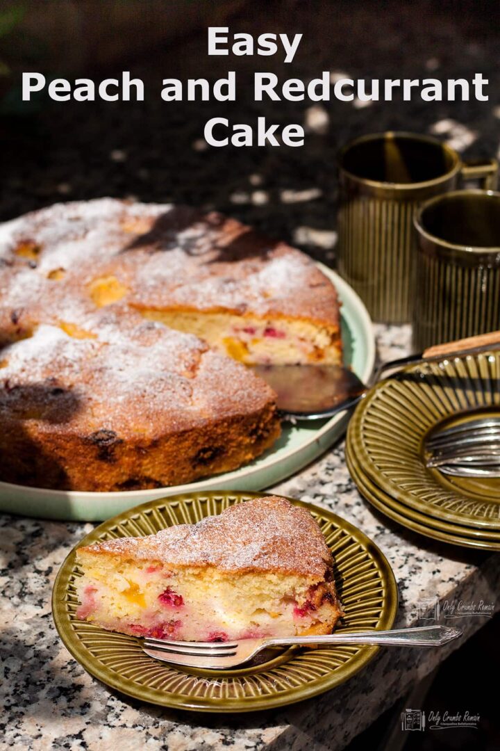 Slice of easy peach and redcurrant cake whole cake behind.