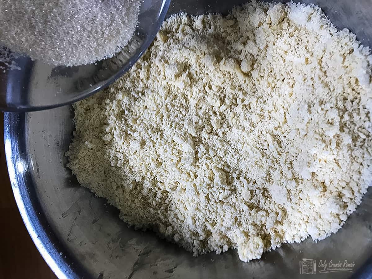adding sugar to butter and flour.