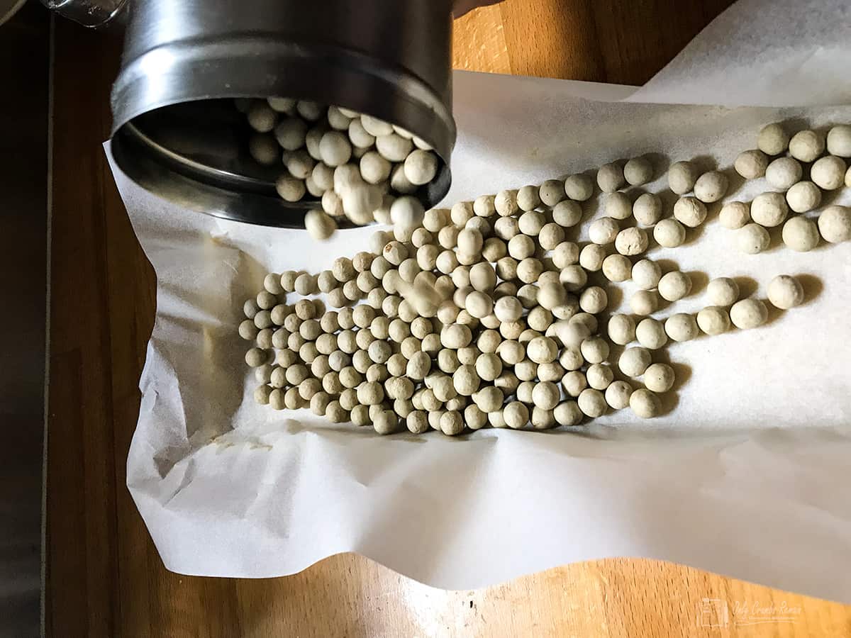pouring baking beans into pastry case.