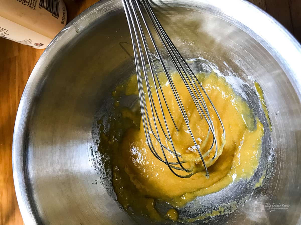 whisking eggs yolks sugar and cornflour together.