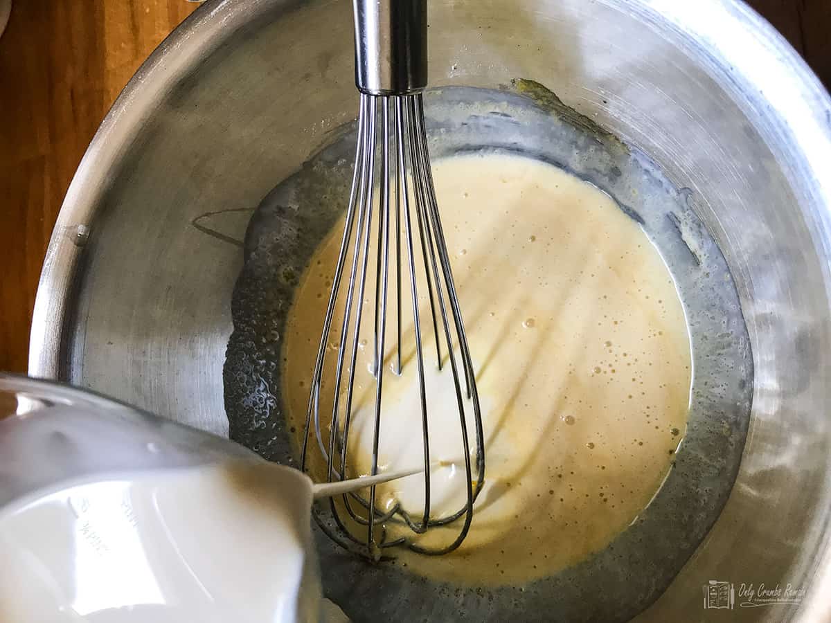 Whisking cream into egg yolk mixture.