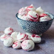 vegan meringue kisses in a bowl and on the table.
