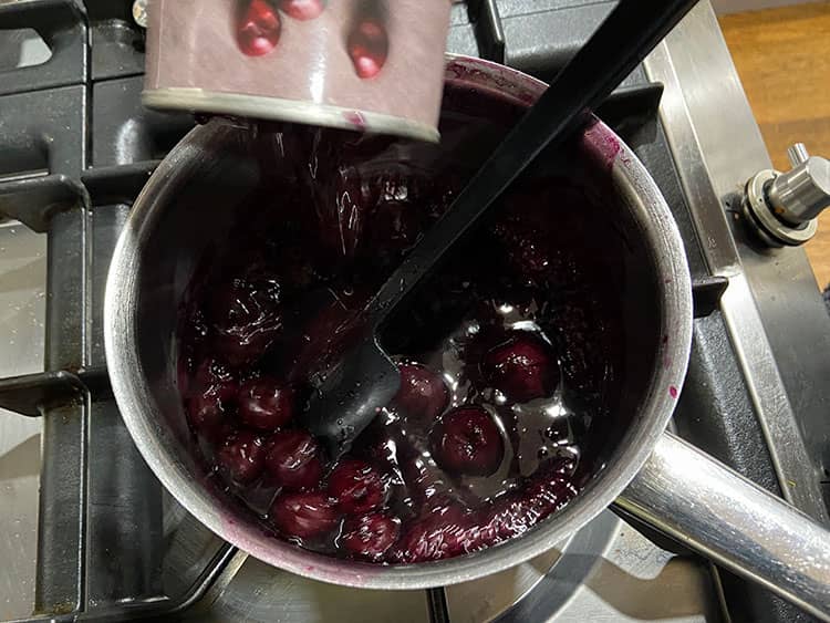 adding cherries to the pan.
