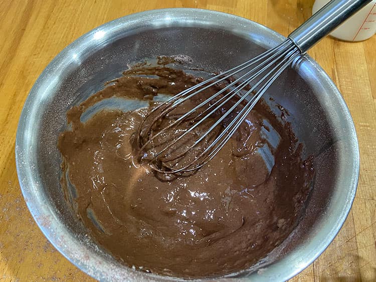 whisking the batter until smooth.