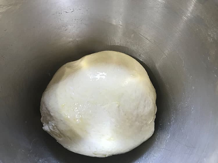 un risen bread dough in bowl.