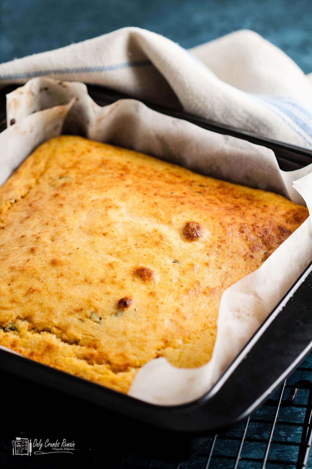 Cornbread with sundried tomatoes and basil in a baking tin.