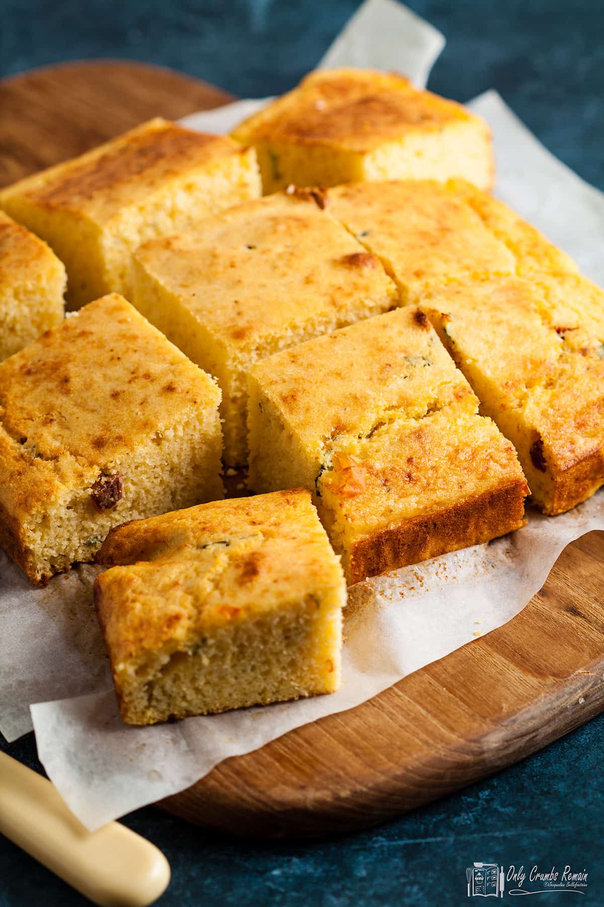 cornbread with sundried tomatoes and basil cut into squares.