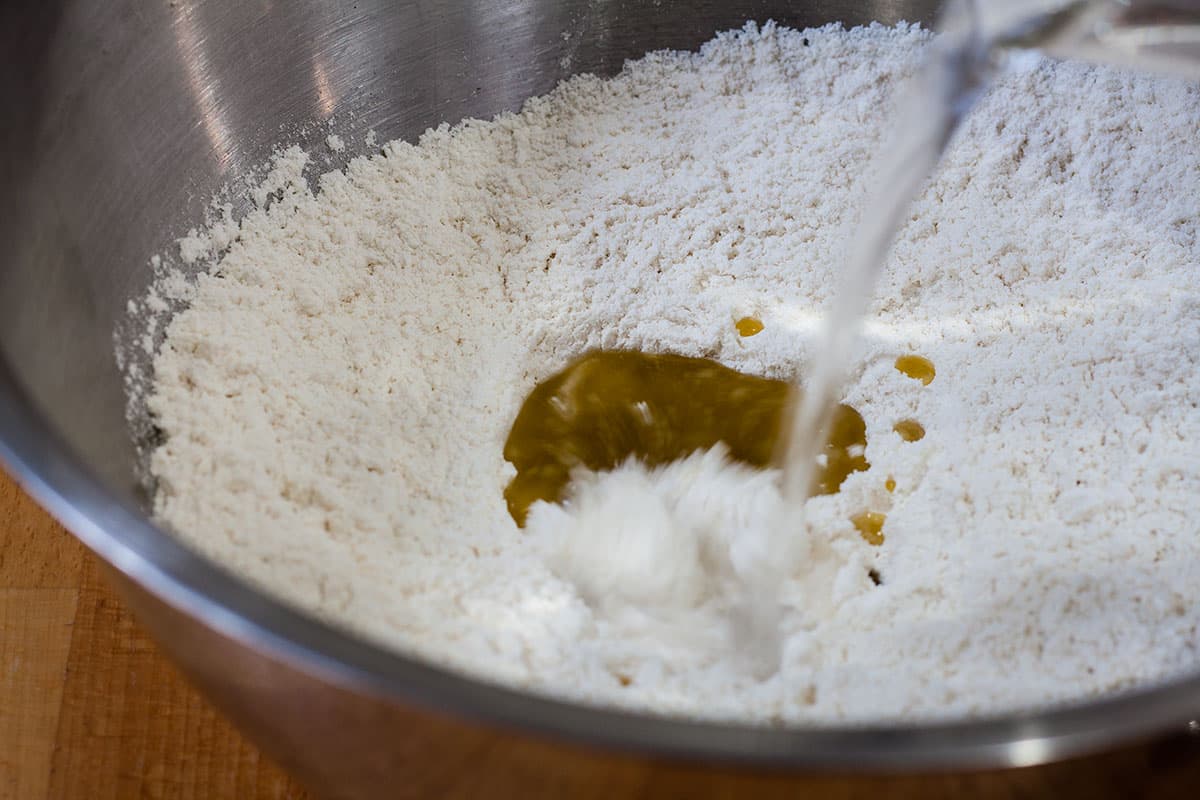 adding water to the flour.