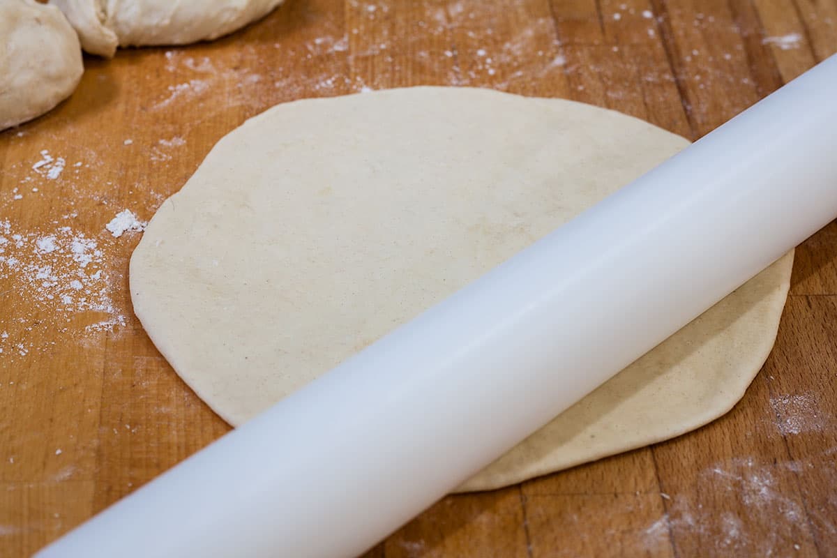 rolling out flatbread.