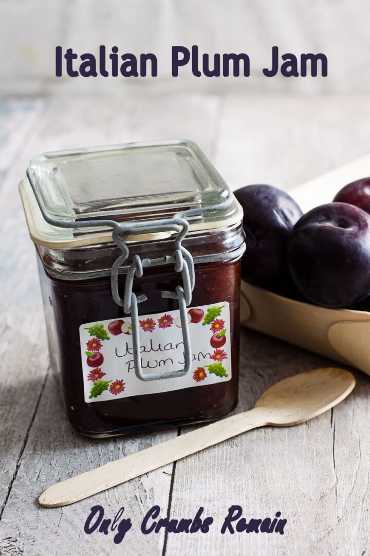 Jar of Italian plum jam with plums in tray to the side.