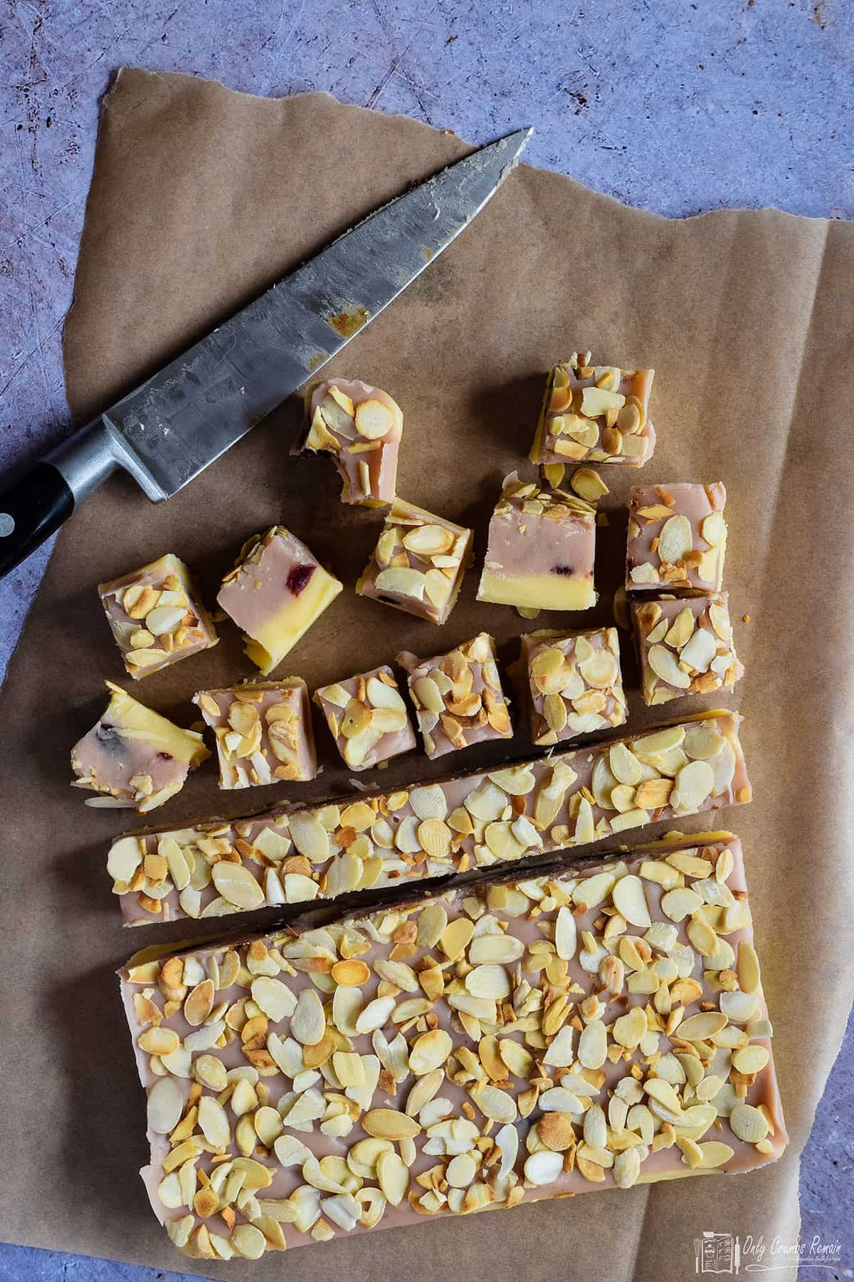 cherry and almond fudge being cut into squares.