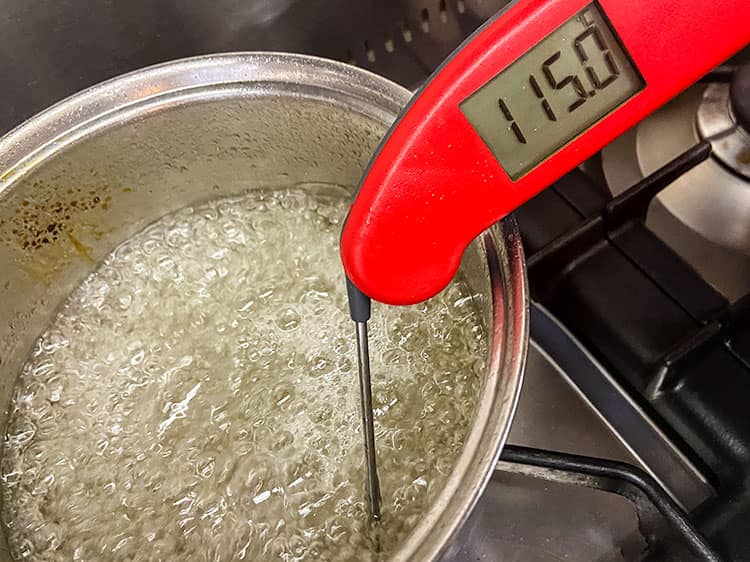 Thermometer in sugar syrup showing 115 ℃