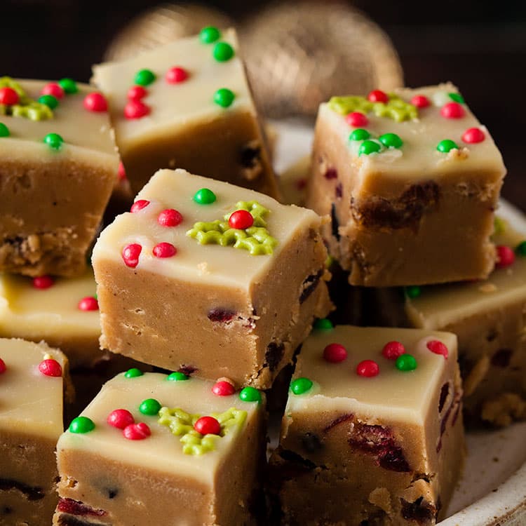 pile of Christmas fudge with festive sprinkles on top.