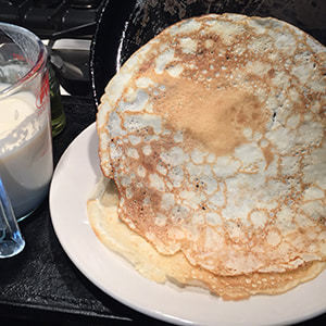 pancakes tipped out from pan to plate.