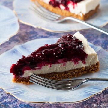 slice of blackcurrant cheesecake on plate with a fork.
