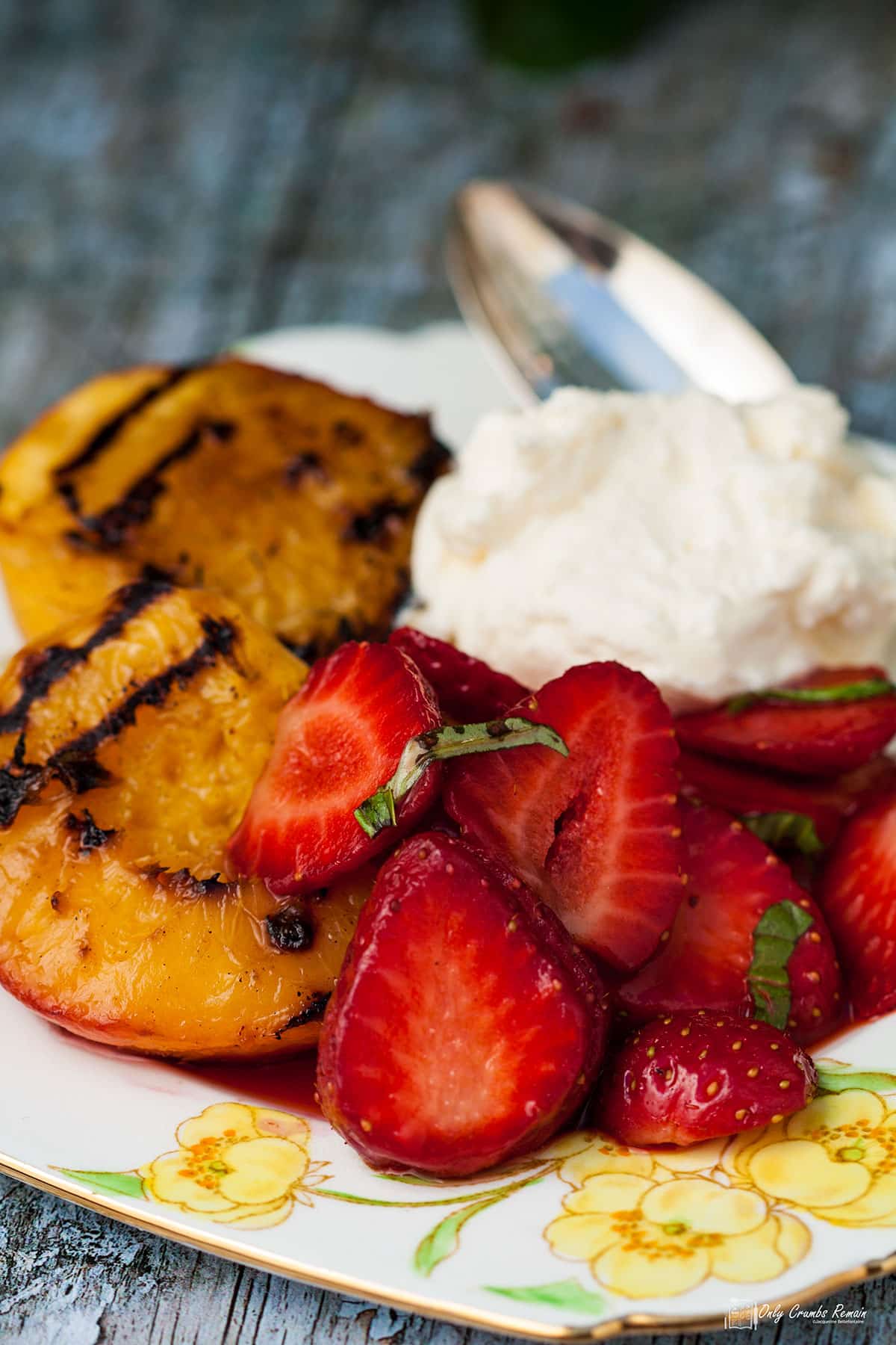 griddled peaches served with macerated strawberries and basil cream.