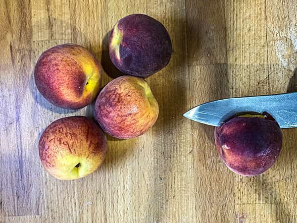 cutting peaches in half.