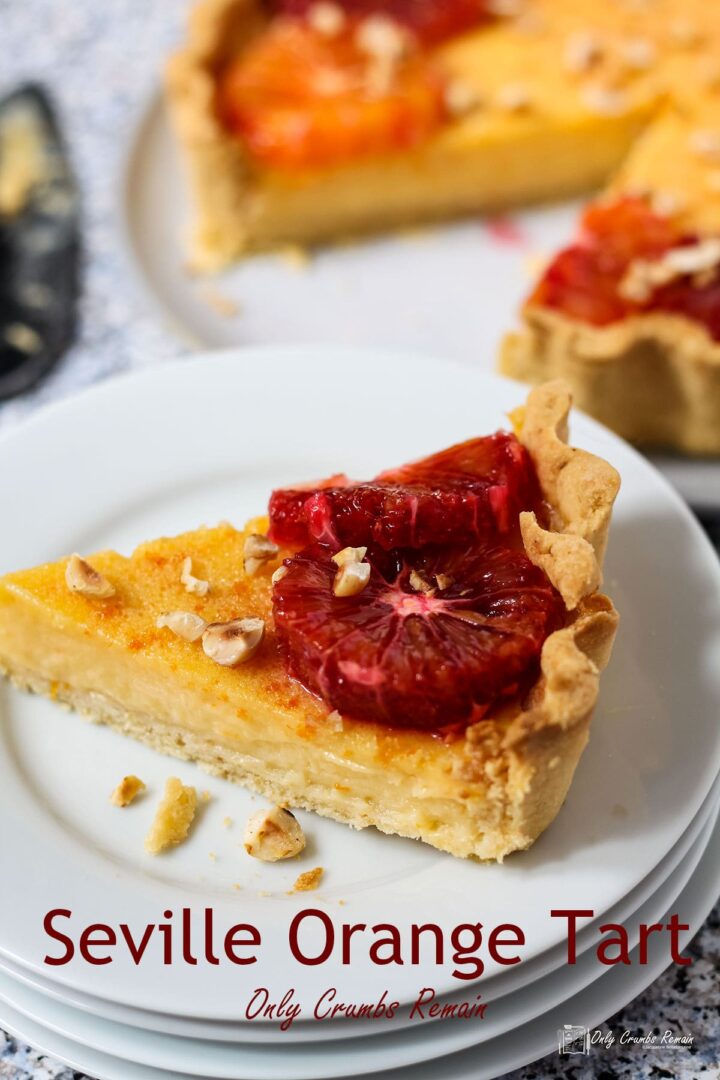 Slice of seville orange tart on plate.