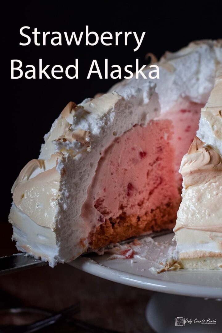 baked alaska on a cake stand with slice removed