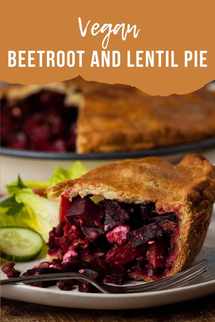 slice of beetroot and lentil pie on a plate with a side salad.