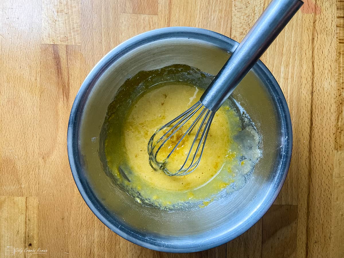 egg yolk sugar and cornflour combined in a bowl with a whisk.